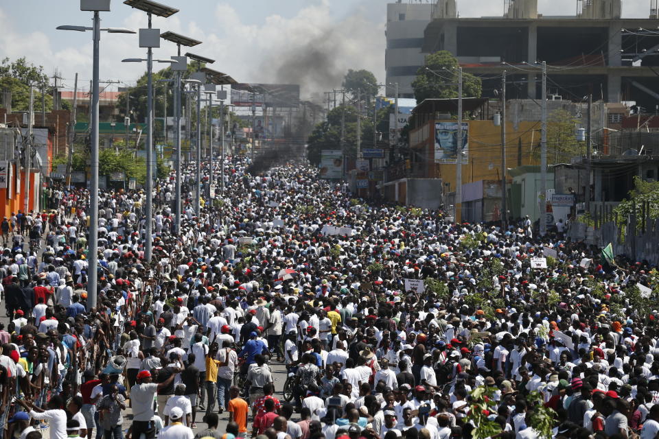 Protesters led by the art community demand the resignation of Haitian President Jovenel Moise as they march through Port-au-Prince, Haiti, Sunday, Oct. 13, 2019. Protests have paralyzed the country for nearly a month, shuttering businesses and schools. (AP Photo/Rebecca Blackwell)