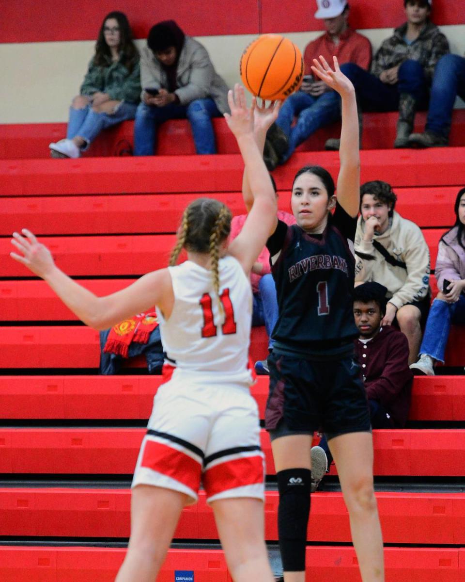 Riverbank guard Livi Fernandez (1) shoots a three during a game between Ripon High School and Riverbank High School at Ripon High School in Ripon California on Jan. 5, 2023.