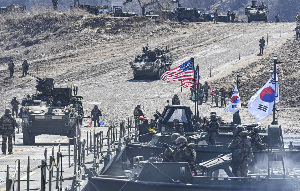 In this photo provided by the South Korea Defense Ministry, South Korean and U.S. soldiers conduct a joint river-crossing drill in Yeoncheon, South Korea, Monday, March 13, 2023. South Korea’s president wants Japan to join his efforts to improve ties frayed over Tokyo’s past colonial rule, saying there is an increasing need for greater bilateral cooperation because of North Korean nuclear threats and global supply chain challenges. (South Korea Defense Ministry via AP)