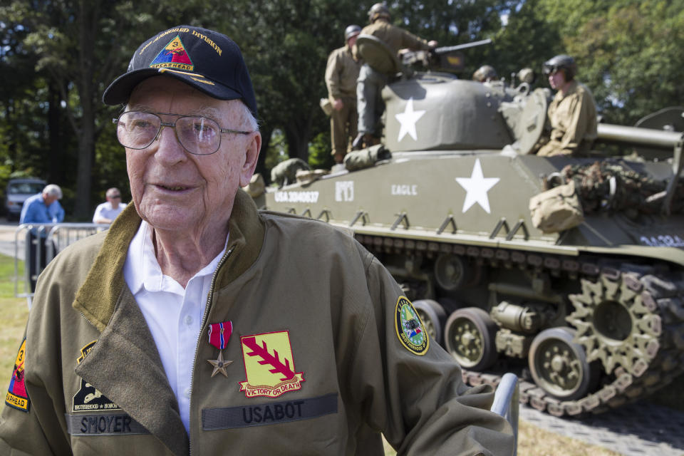 World War II veteran Clarence Smoyer, 96, poses for a picture in front of a Sherman tank after receiving the Bronze Star, near the World War II Memorial, Wednesday, Sept. 18, 2019, in Washington. Smoyer fought with the U.S. Army's 3rd Armored Division, nicknamed the Spearhead Division. In 1945, he defeated a German Panther tank near the cathedral in Cologne, Germany — a dramatic duel filmed by an Army cameraman that was seen all over the world. (AP Photo/Alex Brandon)