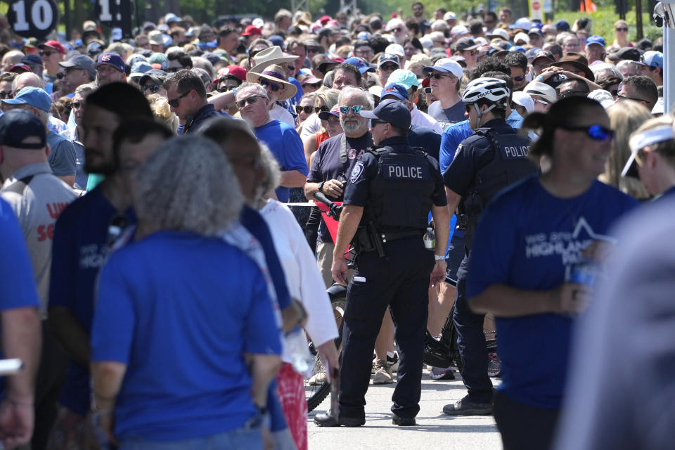 People line up for community walk in Highland Park, Ill., Tuesday, July 4, 2023. One year after a shooter took seven lives at the city's annual parade, community members are planning to honor the victims and reclaim the space to move forward. (AP Photo/Nam Y. Huh)