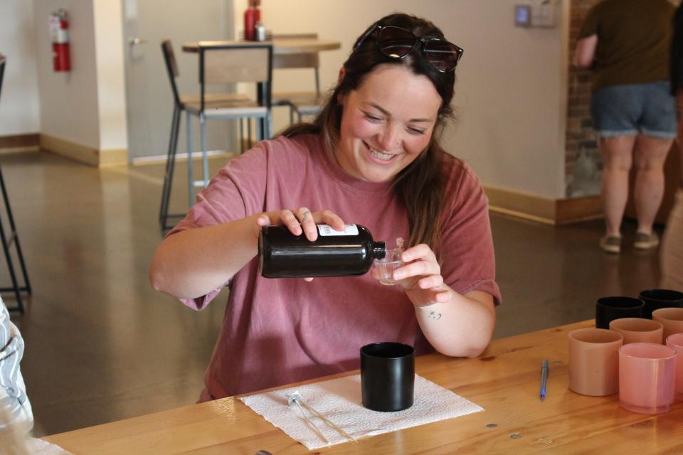 Alivia McBee makes a candle at the Maggie's Farm and Aromatics "Brew and Burn" event at 50 West on July 26, 2023.