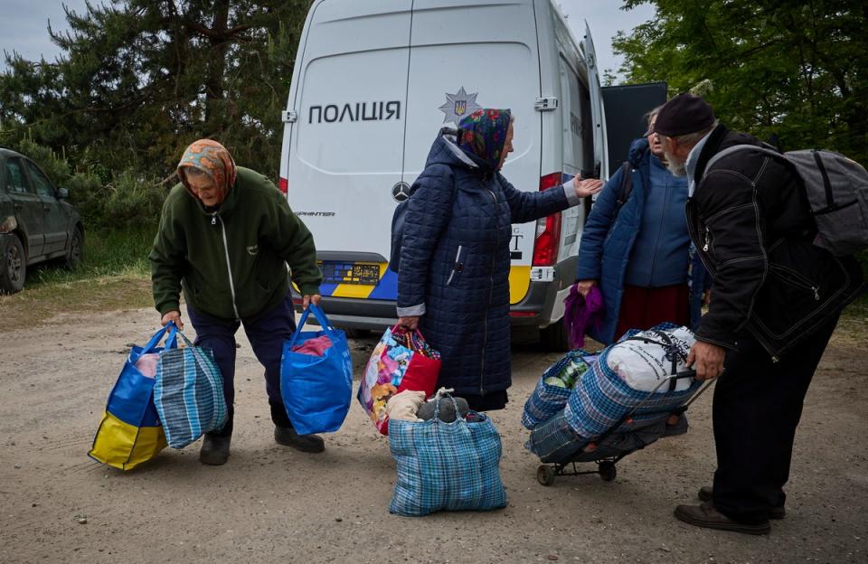 People gather at a mobile evacuation center at an undisclosed location in Kharkiv (EPA)