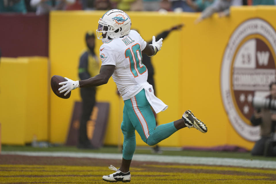 Miami Dolphins wide receiver Tyreek Hill (10) celebrates after scoring against the Washington Commanders during the first half of an NFL football game Sunday, Dec. 3, 2023, in Landover, Md. (AP Photo/Mark Schiefelbein)