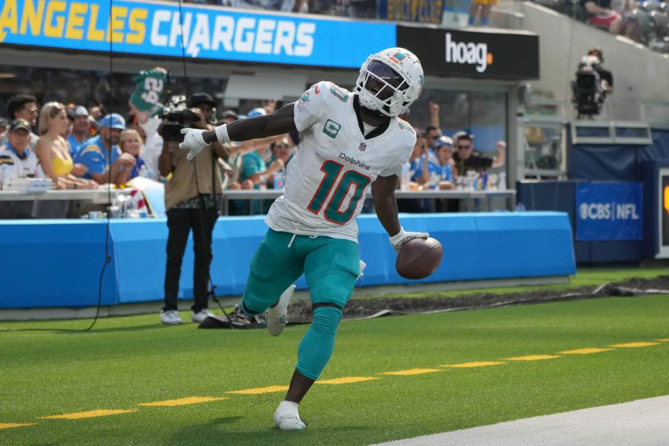 Miami Dolphins wide receiver Tyreek Hill (10) celebrates after catching a 35-yard touchdown pass in the third quarter against the Miami Dolphins at SoFi Stadium.