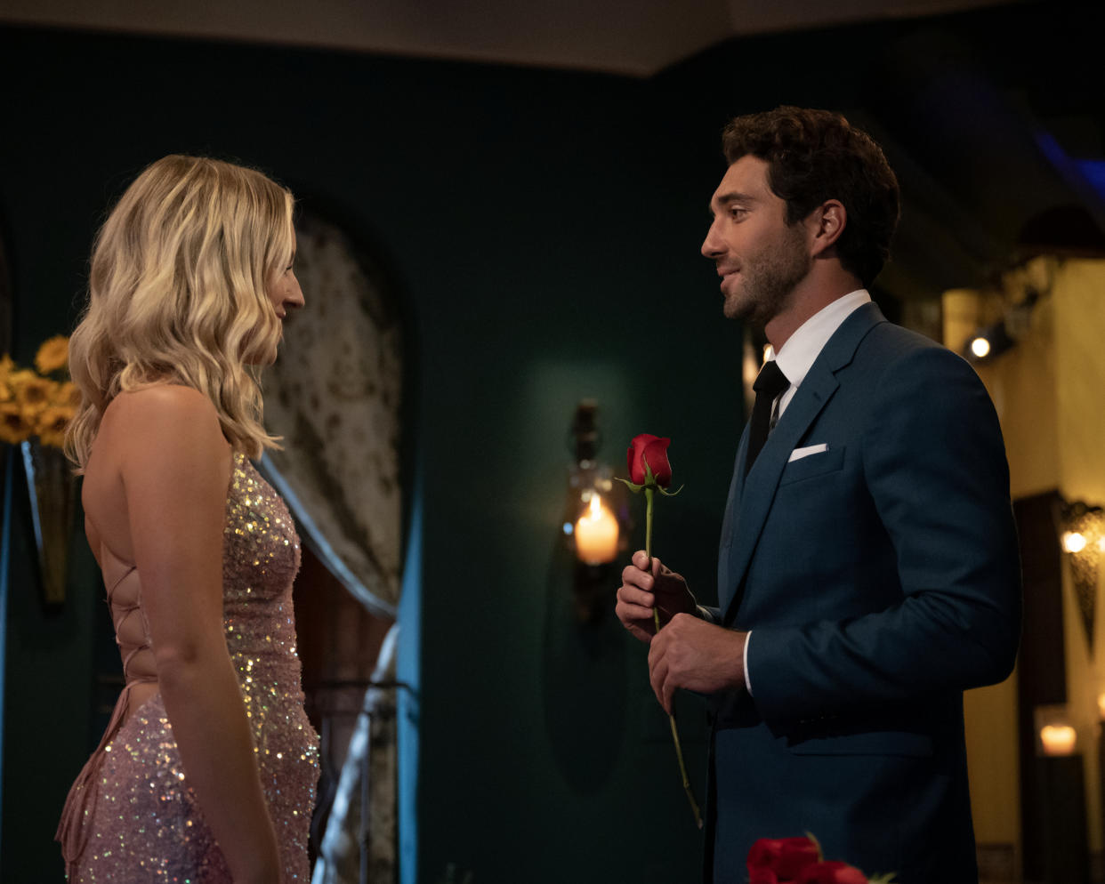 Joey Graziadei handing Daisy Kent a rose during a rose ceremony.