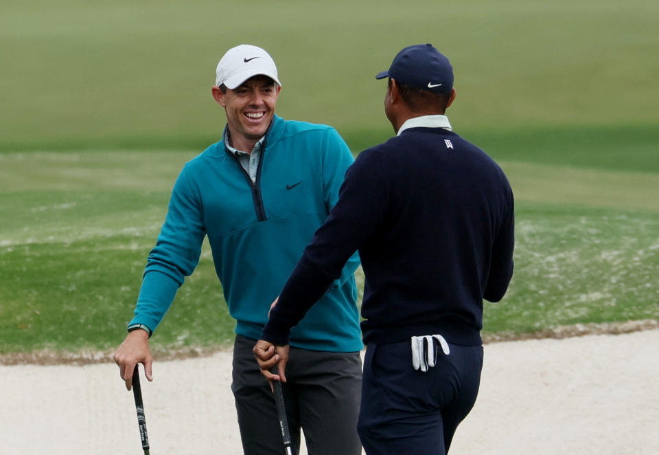 Rory McIlroy chats with you-know-who at Augusta Tuesday. (Mike Segar/Reuters)