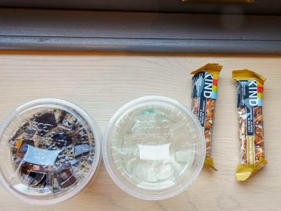 A coffee, a water, and two kind bars.