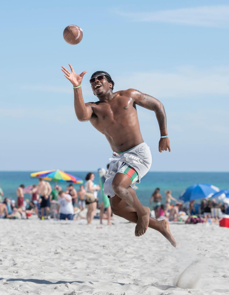 University of West Florida sophomore and Argos football running back Brelan Franks, 21, of Mobile, Alabama, makes a one-handed catch while playing with friends Thursday during spring break at Pensacola Beach.