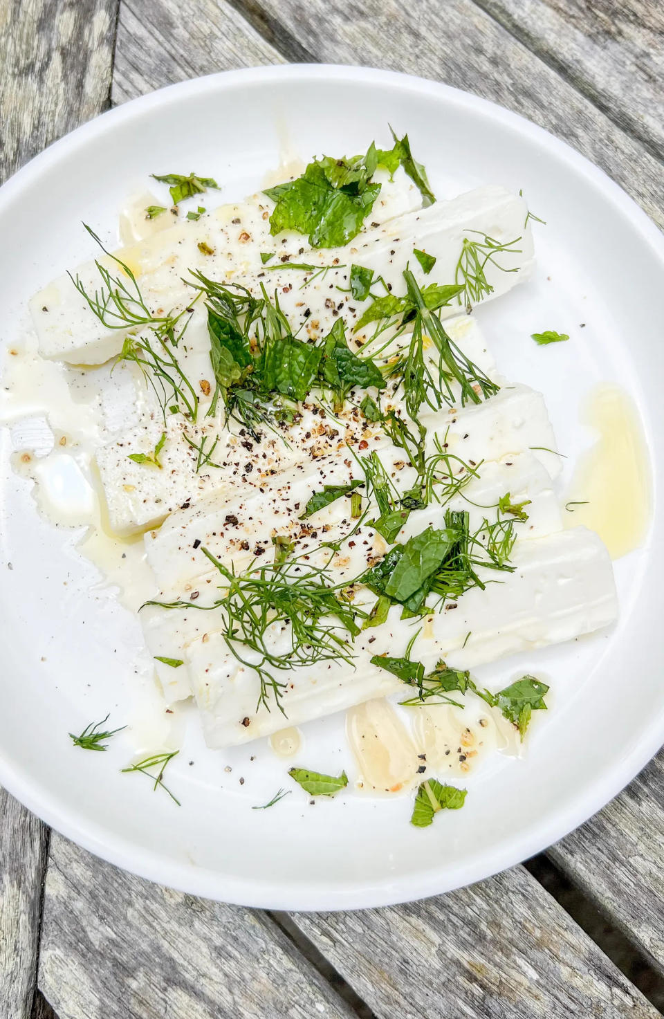 A drizzle of extra-virgin olive oil and honey with a sprinkle of chopped herbs make this feta dish earn its 
