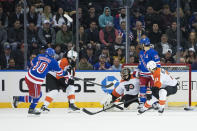 New York Rangers left wing Artemi Panarin (10) scores past Philadelphia Flyers goaltender Samuel Ersson during the first period of an NHL hockey game Thursday, April 11, 2024, at Madison Square Garden in New York. (AP Photo/Mary Altaffer)