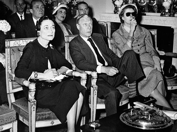 The Duke and Duchess of Windsor watch the coronation of Queen Elizabeth II on the television screen at the Paris home of Mrs. Margaret Biddle (right), the American millionairess   (Photo by PA Images via Getty Images)