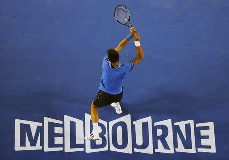 Novak Djokovic of Serbia hits a return to Stan Wawrinka of Switzerland during their men's singles semi-final match at the Australian Open 2015 tennis tournament in Melbourne January 30, 2015. REUTERS/Carlos Barria