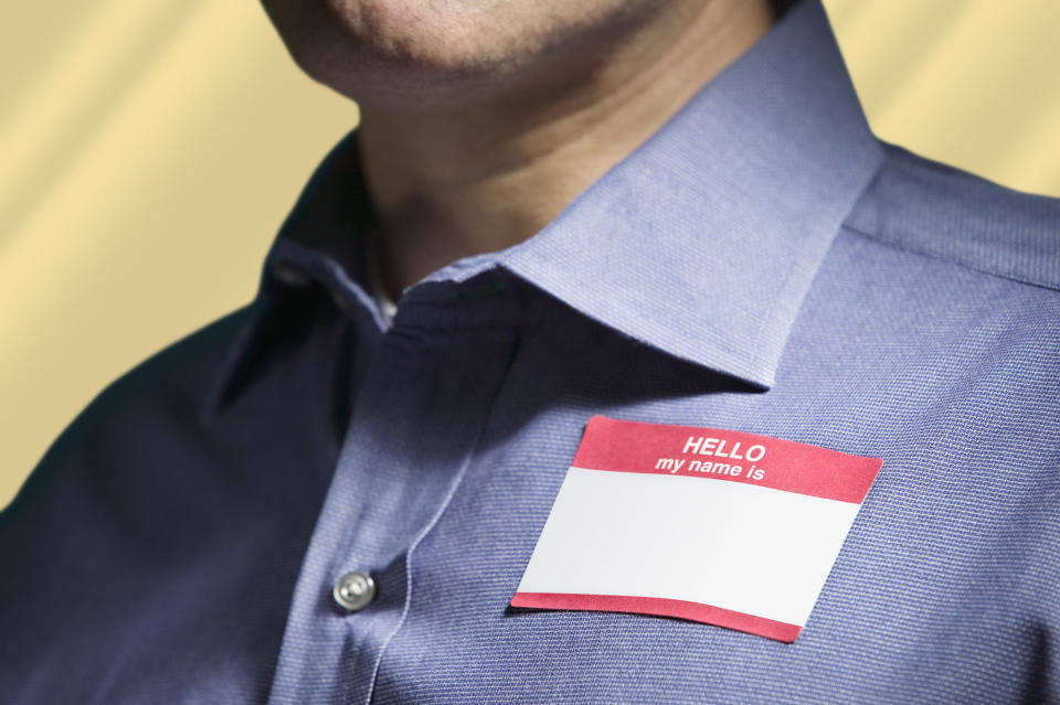 A blank "Hello, my name is..." tag on a man's shirt