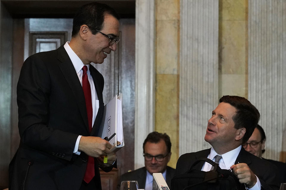 WASHINGTON, DC - OCTOBER 16:  U.S. Secretary of the Treasury Steven Mnuchin (L) talks to Chairman of Securities and Exchange Commission Jay Clayton (R) during a Financial Stability Oversight Council meeting October 16, 2018 at the Treasury Department in Washington, DC.  (Photo by Alex Wong/Getty Images)