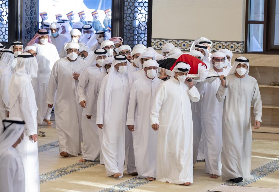 This photo made available by the Ministry of Presidential Affairs, shows UAE Crown Prince Sheikh Mohamed bin Zayed Al Nahyan, ruler of Abu Dhabi, front right, and Sheikh Mansour bin Zayed Al Nahyan, UAE Deputy Prime Minister and Minister of Presidential Affairs, front left, carry the body of Sheikh Khalifa bin Zayed Al Nahyan, president of the United Arab Emirates, with other members of royal family at Sheikh Sultan bin Zayed The First mosque, in Abu Dhabi, Friday, May 13, 2022. (Abdulla Al Neyadi/Ministry of Presidential Affairs via AP)