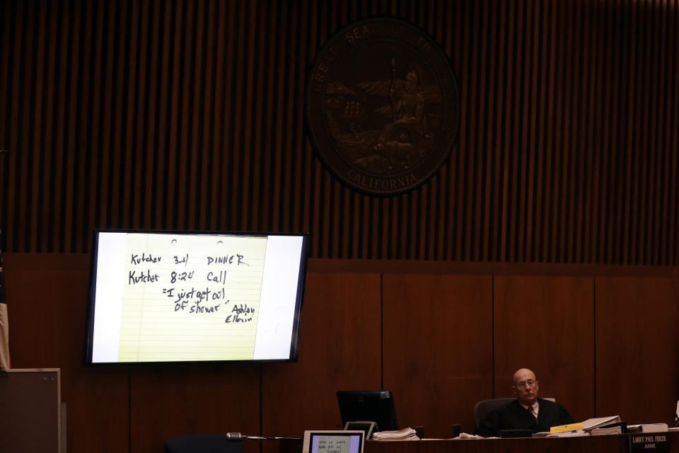 Notes from a conversation between actor Ashton Kutcher and his ex-girlfriend Ashley Ellerin, one of Michael Gargiulo's alleged victims, are presented on a slide as Judge Larry P. Fidler, right, listens during closing arguments in the trial of People vs. Michael Gargiulo Wednesday, Aug. 7, 2019, in Los Angeles. Closing arguments continued Wednesday in the trial of the air conditioning repairman charged with killing two Southern California women and attempting to kill a third. (AP Photo/Marcio Jose Sanchez, Pool)