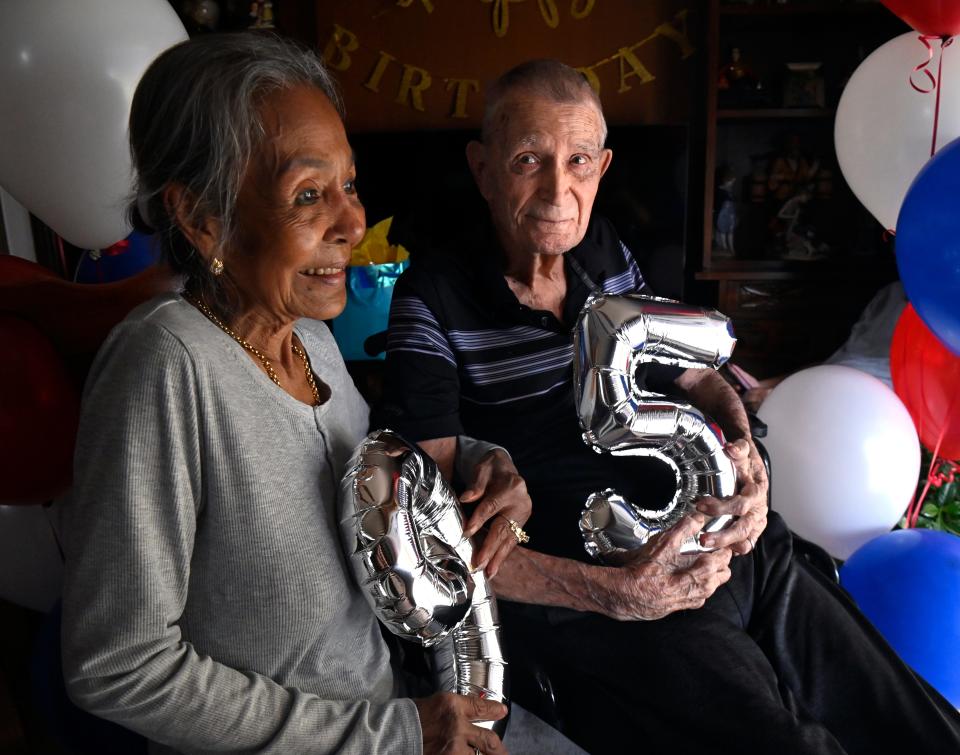 Dwight Painter glances at his wife Daw as they sit for a picture on his 95th birthday party.