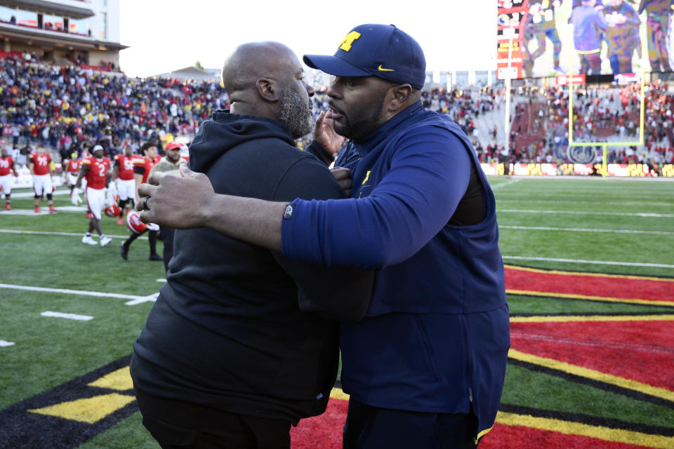 FILE - Michigan acting head coach Sherrone Moore, right, and Maryland head coach Mike Locksley, left, greet each other after an NCAA college football game, Saturday, Nov. 18, 2023, in College Park, Md. Locksley is the founder of the National Coalition of Minority Football Coaches. (AP Photo/Nick Wass, File)