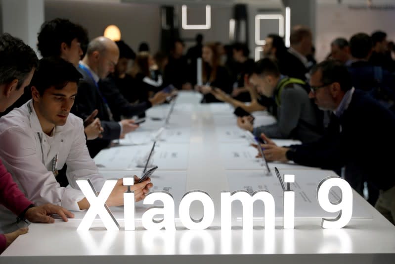 FILE PHOTO: Visitors visit the Xiaomi booth at the Mobile World Congress in Barcelona