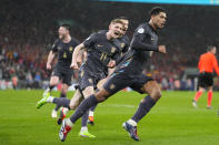 England's Jude Bellingham, right, celebrates after scoring his side's second goal during an international friendly soccer match between England and Belgium at Wembley Stadium, in London, Tuesday, March 26, 2024. (AP Photo/Kirsty Wigglesworth)