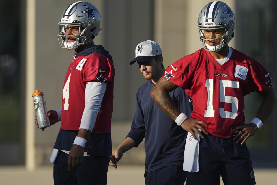 Dallas Cowboys quarterbacks Dak Prescott (4) and Trey Lance (15) look on during NFL football practice in Frisco, Texas, Wednesday, Aug. 30, 2023. (AP Photo/LM Otero)