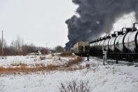 Smoke rises from a fire at the site of a CP Rail train car derailment near Guernsey