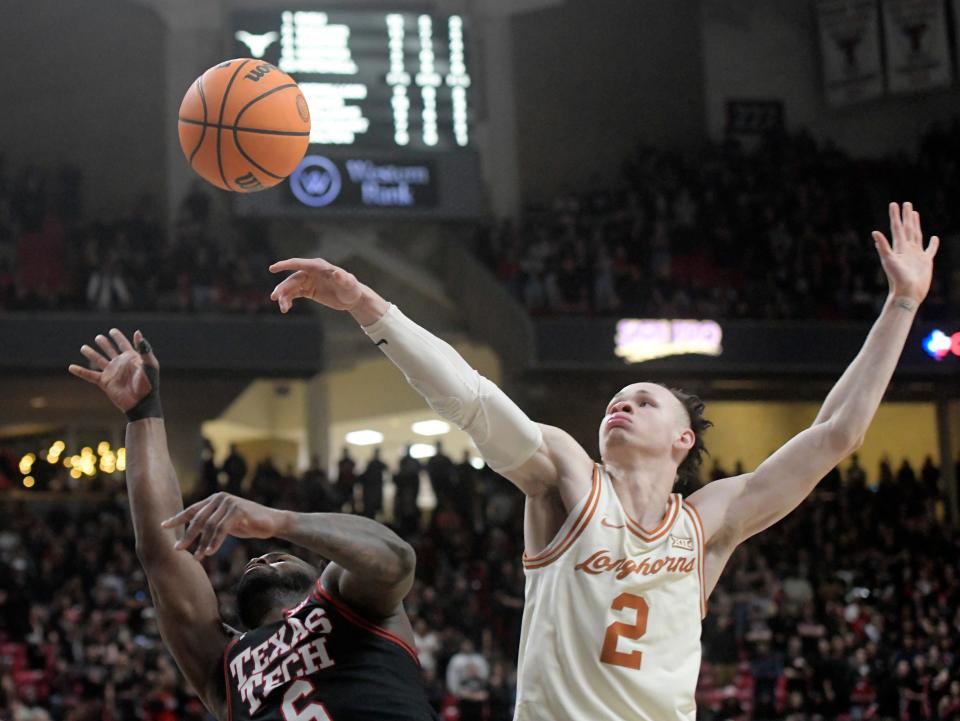 Texas guard Chendall Weaver, right, contests a shot by Texas Tech's Joe Toussaint in the Longhorns' 81-69 win Tuesday at United Supermarkets Arena in Lubbock. Weaver had 15 points and eight rebounds off the bench in the emotional win.