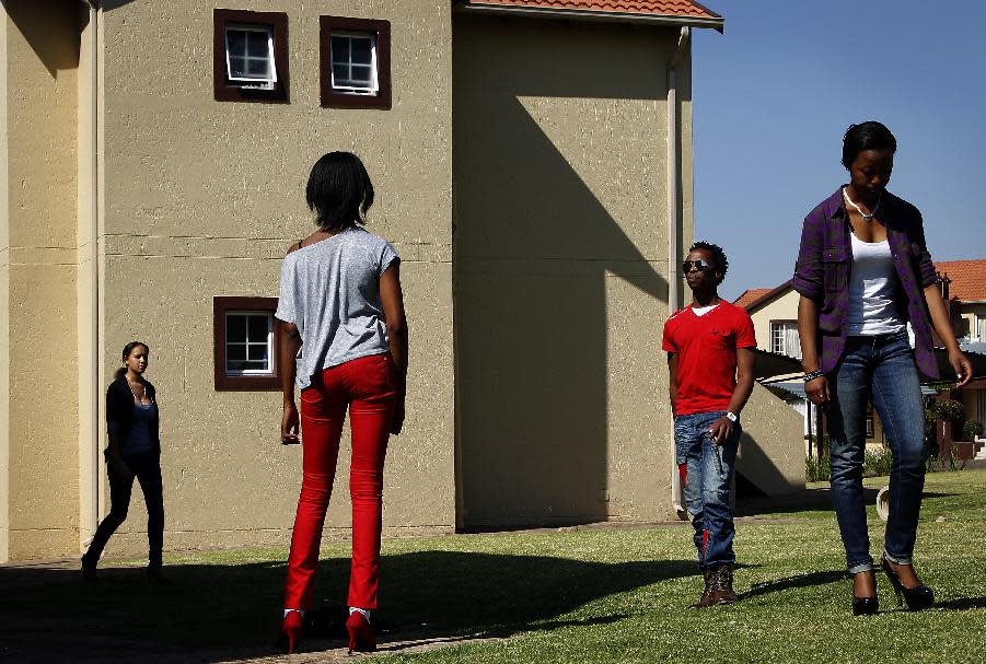 In this photograph shot Saturday May 19, 2012, fashion models rehearse in a Johannesburg, South Africa residential neighborhood for the Soweto Fashion Week scheduled to start Thursday May 24, 2012. Designers and entrepreneurs who have gotten together to put on a fashion show in Soweto are inspired by the famed township's creativity and history.(AP Photo/Jerome Delay)