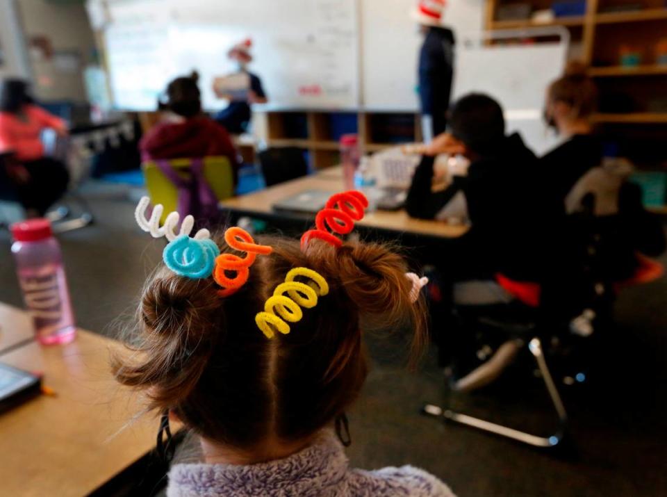 Fun and wild hair decorations are part of the annual Read Across America event celebrating Dr. Seuss and his children books. Members of the National Junior Honor Society students from Highlands Middle School in Kennewick take part in the annual celebration Wednesday by reading to younger students at Westgate Elementary School.