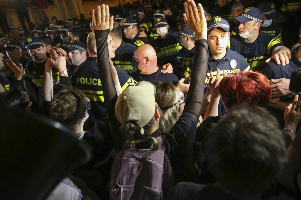 A demonstrator gestures while arguing with the police during an opposition protest against "the Russian law" near the Parliament building in Tbilisi, Georgia, on Wednesday, May 1, 2024. Protesters denounce the bill as "the Russian law" because Moscow uses similar legislation to stigmatize independent news media and organizations critical of the Kremlin. (AP Photo/Zurab Tsertsvadze)