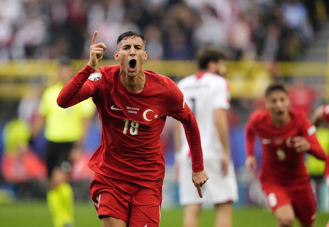 Mert Muldur points to the sky after scoring a wonder goal for Turkey