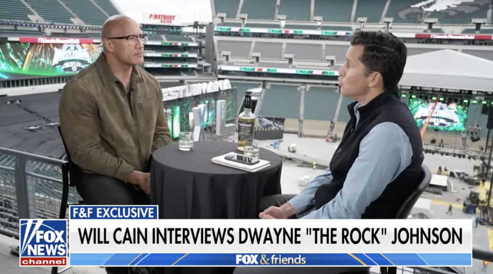 Will Cain interviewing Dwayne "The Rock" Johnson on a stadium set for FOX News Channel's show