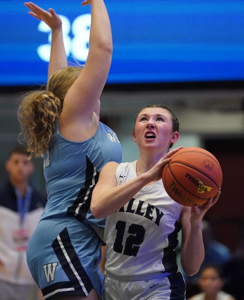 Putnam Valley's Ava Harman (12) drives on Westlake's Margaret Plotkin (21) in the Section 1 Class B girls basketball championship game at the Westchester County Center in White Plains on Friday, March 1, 2024.