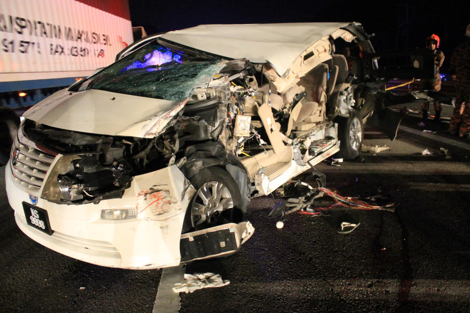 The damaged car which veteran Malaysian opposition lawmaker Karpal Singh was traveling in, sits on a highway near Gopeng, Malaysia, Thursday, April 17, 2014. Singh, an eminent lawyer who had been detained without trial under security laws and battled numerous sedition charges, died early Thursday in a road accident. He was 73. (AP Photo) MALAYSIA OUT, NO SALES, NO ARCHIVE