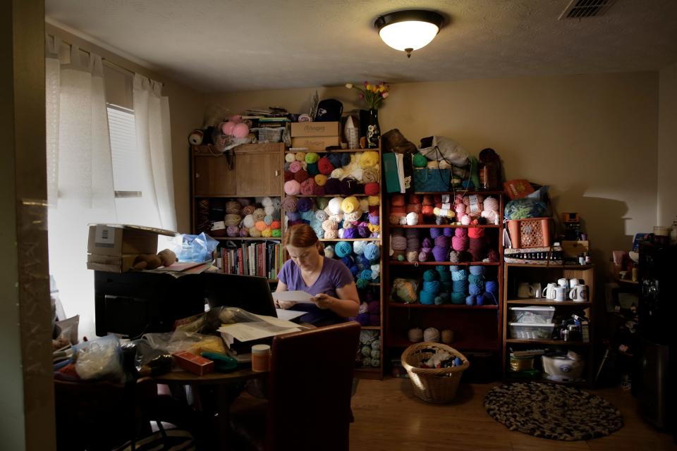 Michelle Mealey sorts through years of paperwork in a work room at her Orange Park home. The yarn collection is from a project she started to knit small animals during the pandemic. Michelle's husband of 23 years, Jason Mealey died suddenly of a heart attack several weeks ago while mowing the lawn. They were big fans of the Welcome to Rockville music festival and had tickets for this year's event in Daytona Beach. Now, Michelle plans to make the trip to the festival with friends to honor his memory.