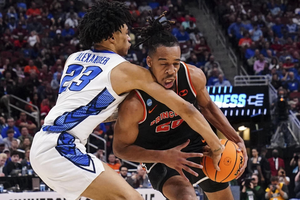 Princeton forward Tosan Evbuomwan (20) is fouled by Creighton guard Trey Alexander (23) in the first half of a Sweet 16 round college basketball game in the South Regional of the NCAA Tournament, Friday, March 24, 2023, in Louisville, Ky. (AP Photo/John Bazemore)