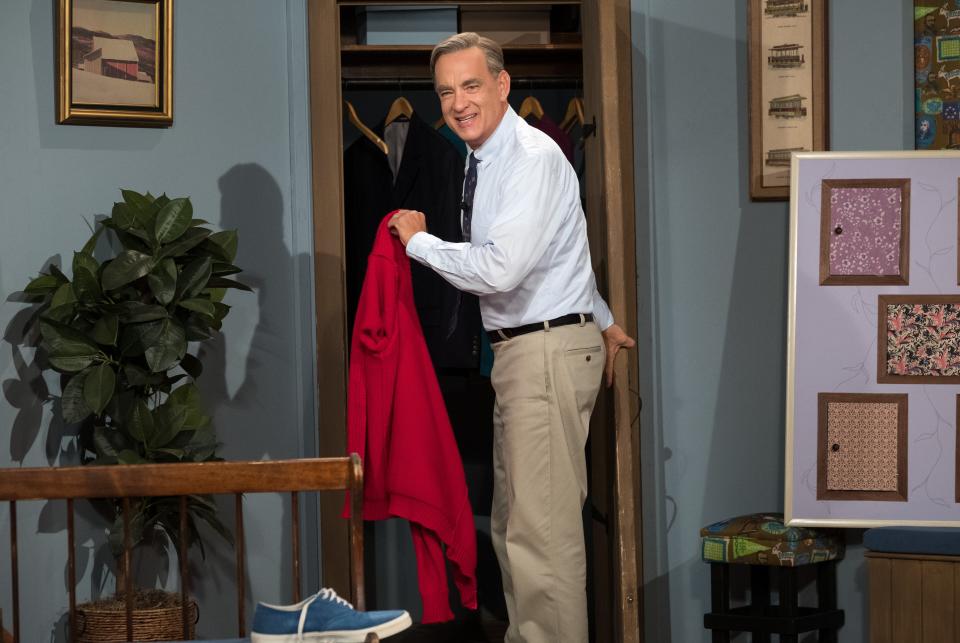 Tom Hanks wears the red sweater and wise demeanor of children's TV icon Mister Rogers in "A Beautiful Day in the Neighborhood."