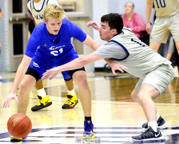 Oklahoma Wesleyan University guard Austin Poling, right, guards a Tabor ballhandler during men's basketball action on Jan. 11, 2023, at the Mueller Sports Center.