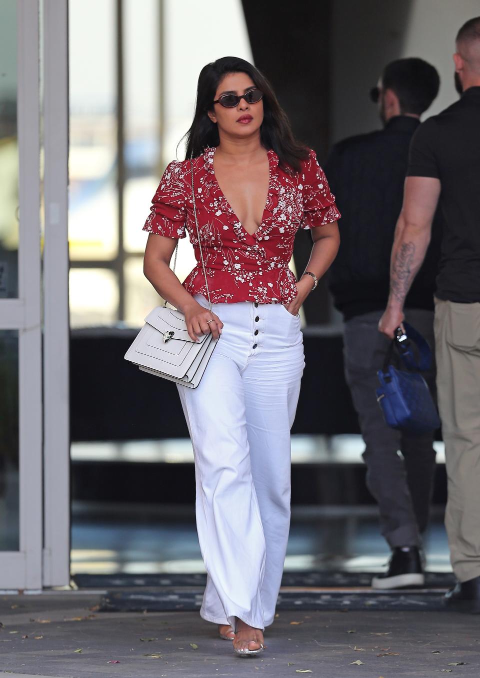 <h1 class="title">EXCLUSIVE: Priyanka Chopra Looks Radiant In A Plunging Red Blouse As She Touches Down At Million Air Burbank In Los Angeles, CA</h1><cite class="credit">SplashNews.com</cite>