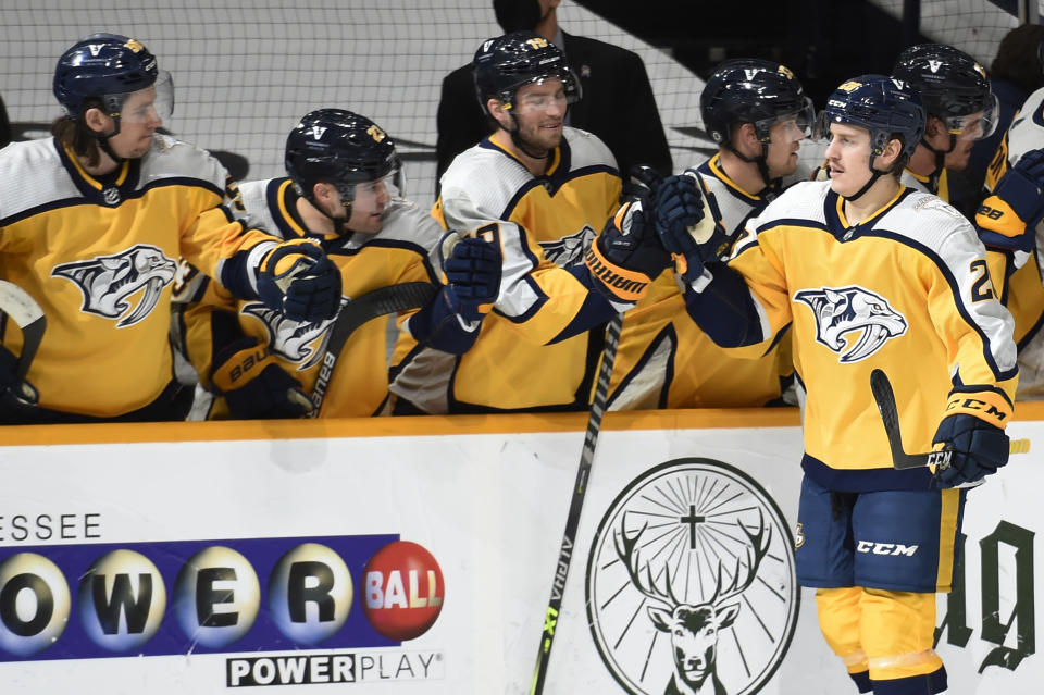 Nashville Predators right wing Eeli Tolvanen (28) is congratulated after scoring a goal against the Florida Panthers during the first period of an NHL hockey game Saturday, March 6, 2021, in Nashville, Tenn. (AP Photo/Mark Zaleski)