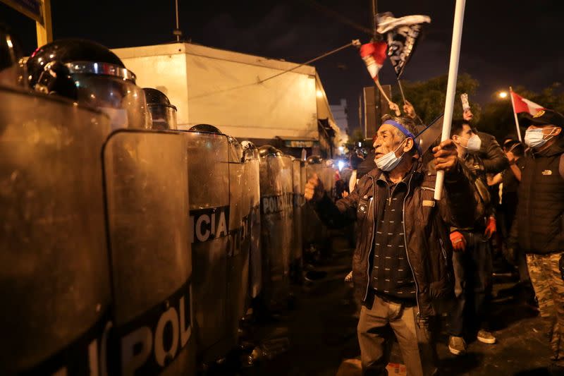 A demonstrator reacts towards police during protests following the impeachment of President Martin Vizcarra, in Lima