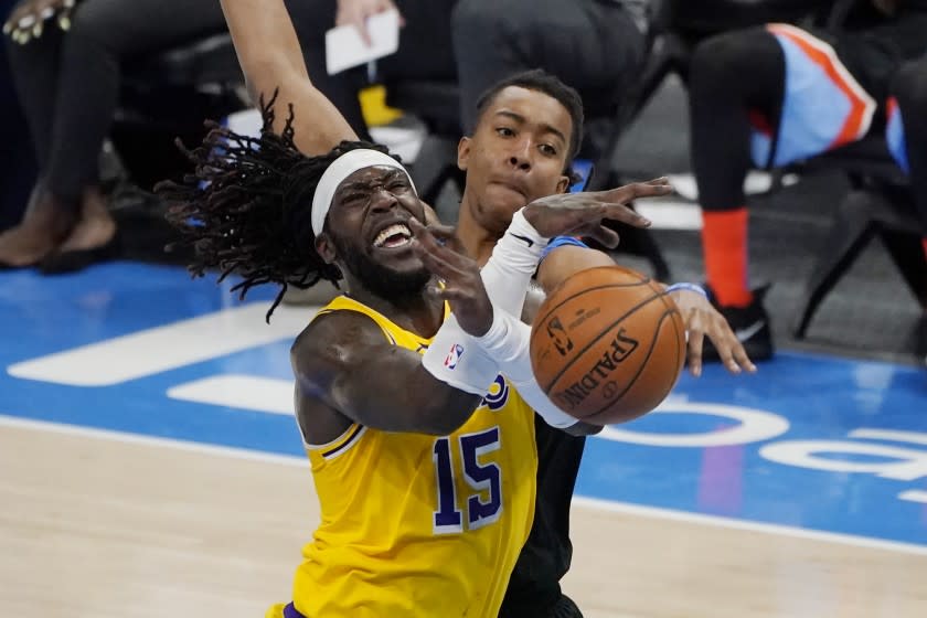 Los Angeles Lakers center Montrezl Harrell (15) is fouled by Oklahoma City Thunder center Moses Brown, rear, in the second half of an NBA basketball game Wednesday, Jan. 13, 2021, in Oklahoma City. (AP Photo/Sue Ogrocki)