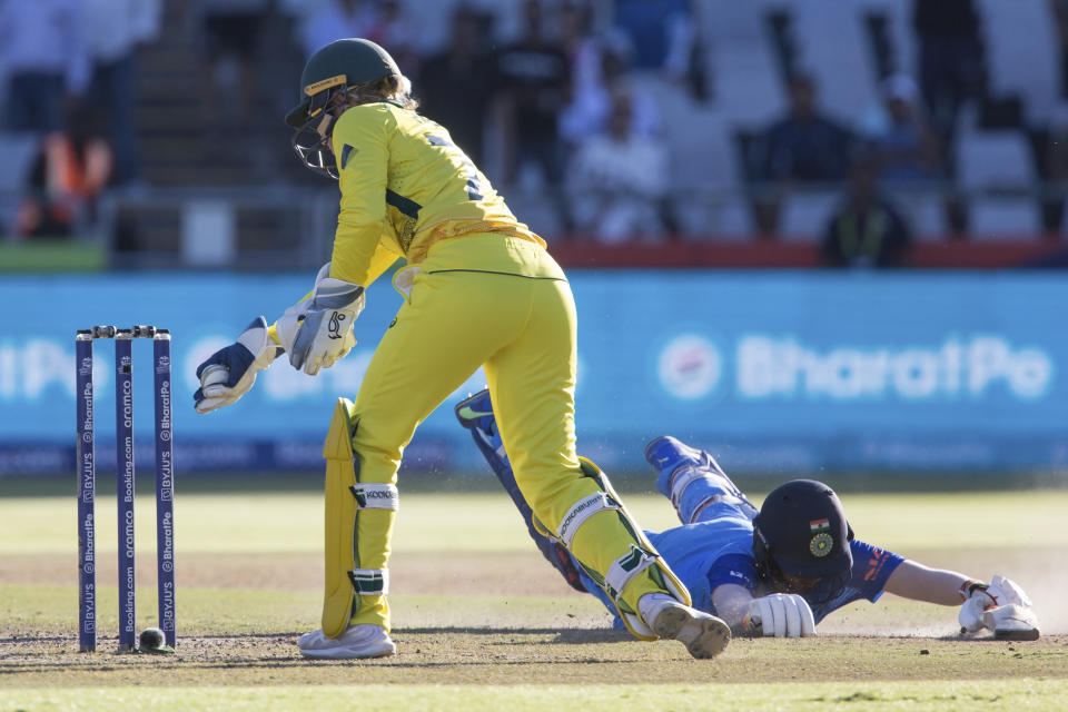 India's Deepti Sharma dives for the crease as Australia's Alyssa Healy attempts the run out during the Women's T20 World Cup semi final cricket match in Cape Town, South Africa, Thursday Feb. 23, 2023. (AP Photo/Halden Krog)