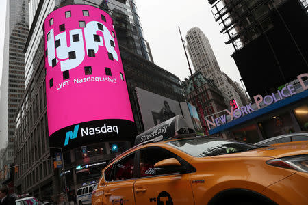 FILE PHOTO: Signage for Lyft is seen displayed at the NASDAQ MarketSite in Times Square in celebration of its initial public offering (IPO) on the NASDAQ Stock Market in New York, U.S., March 29, 2019. REUTERS/Shannon Stapleton/File Photo