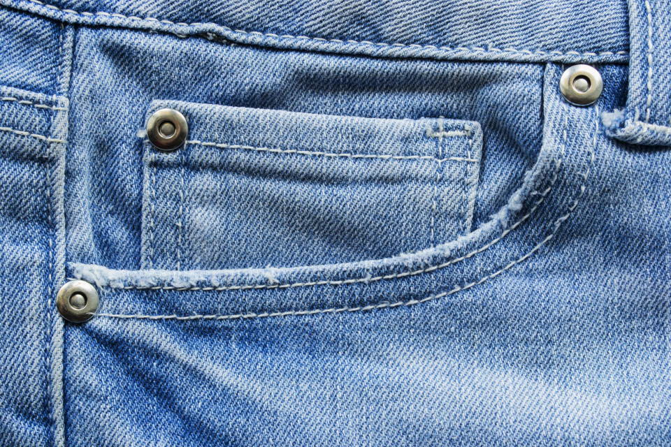 A closeup of pockets on a pair of blue jeans