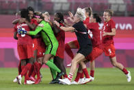 Canada's players celebrate after winning 1-0 to United States during a women's semifinal soccer match at the 2020 Summer Olympics, Monday, Aug. 2, 2021, in Kashima, Japan. (AP Photo/Fernando Vergara)