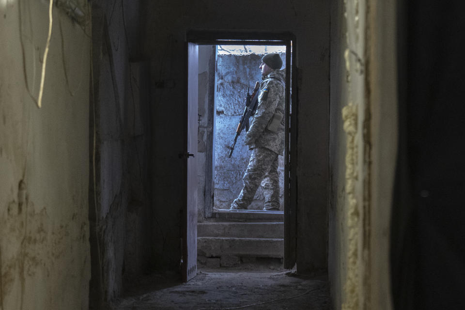 FILE - A Ukrainian soldier stands outside a shelter in the front-line city of Kupiansk, Kharkiv region, Ukraine, Thursday, Nov. 30, 2023. Approval by the U.S. House of a $61 billion package for Ukraine puts the country a step closer to getting an infusion of new firepower. But the clock is ticking. Russia is using all its might to achieve its most significant gains since the invasion by a May 9 deadline. (AP Photo/Efrem Lukatsky, File)