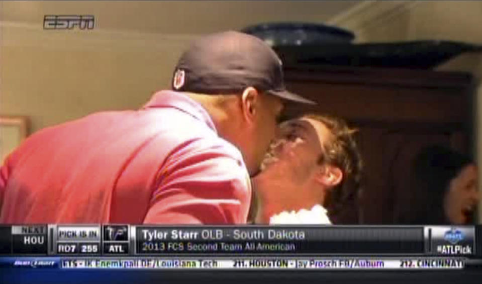 Missouri defensive end Michael Sam, left, kisses Vito Cammisano at a draft party in San Diego, after he was selected in the seventh round, 249th overall, by the St. Louis Rams in the NFL draft. (AP Photo/ESPN)