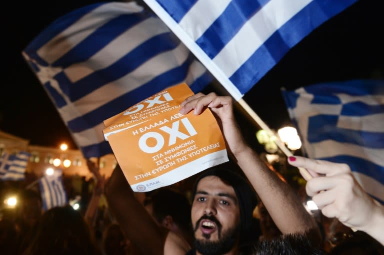 People celebrate in Athens after early referendum results show a large 'No' majority